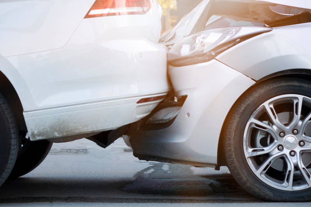 car crash showing bumpers of two cars hitting