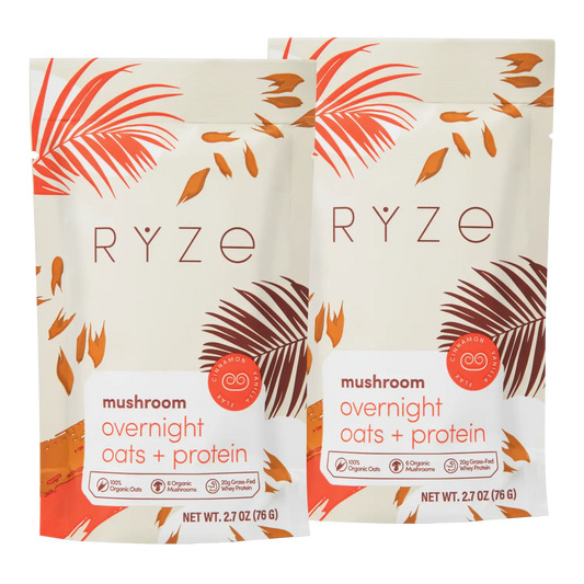 Two packages of RYZE mushroom overnight oats and protein on a white background