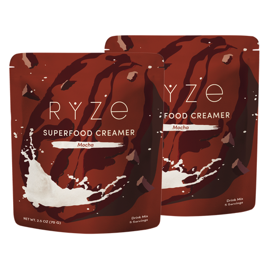 Two pouches of RYZE Food Creamer Superfood Creamer in Mocha flavor, displayed against a plain white background.