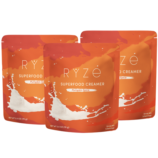 Three stand-up pouches of Ryze Superfood Creamer in Pumpkin Spice flavor, arranged in a fan shape on a plain white background.
