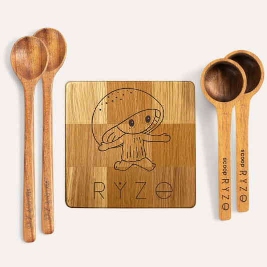 Wooden drink coaster with engraved RYE Mushroom design and text, accompanied by wooden spoons and scoops on a white background.