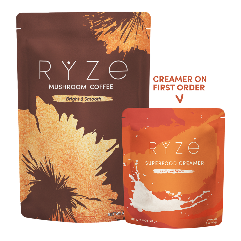 Two RYZE-branded pouches on a white background: a larger brown and gold Mushroom Coffee pouch and a smaller orange and orange-red Superfood Creamer pouch, with text reading 'CREAMER ON FIRST ORDER' and a checkmark.