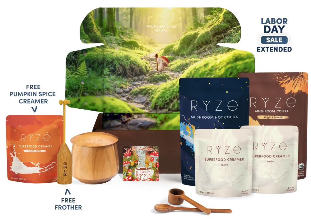 RYZE Labor Day gift set featuring mushroom hot cocoa, mushroom coffee, pumpkin spice creamer, and a free frother, arranged in front of a forest-themed box on a white background with 'Labor Day Sale Extended' text.
