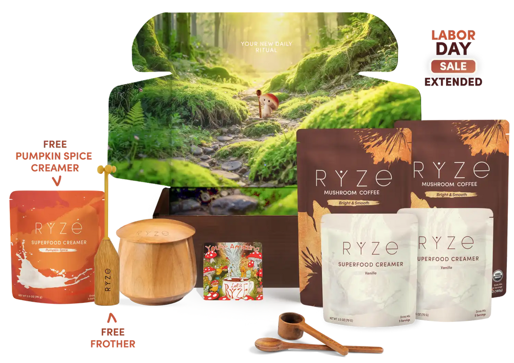 A RYZE Labor Day gift set featuring mushroom coffee, superfood creamer pouches, a wooden jar, a small wooden spoon, a wooden frother, and a decorative forest-themed box on a white background with sale text.