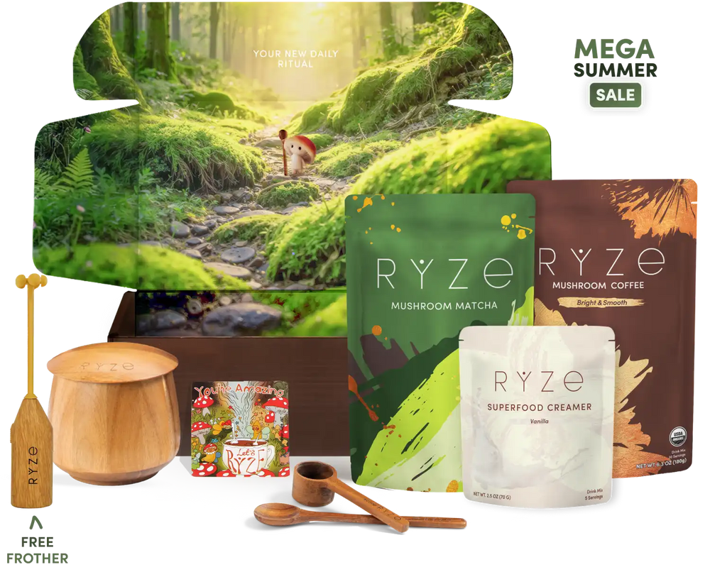 A RYZE mushroom coffee and matcha gift set displayed on a white background, featuring a forest-themed box, a green matcha pouch, a brown coffee pouch, a white creamer pouch, wooden spoons, a wooden container, and a free frother.