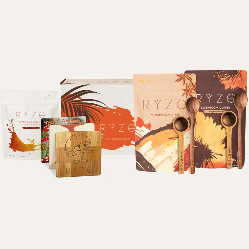 Collection of RYZE mushroom coffee products including packaging, wooden spoon, and card on a white background