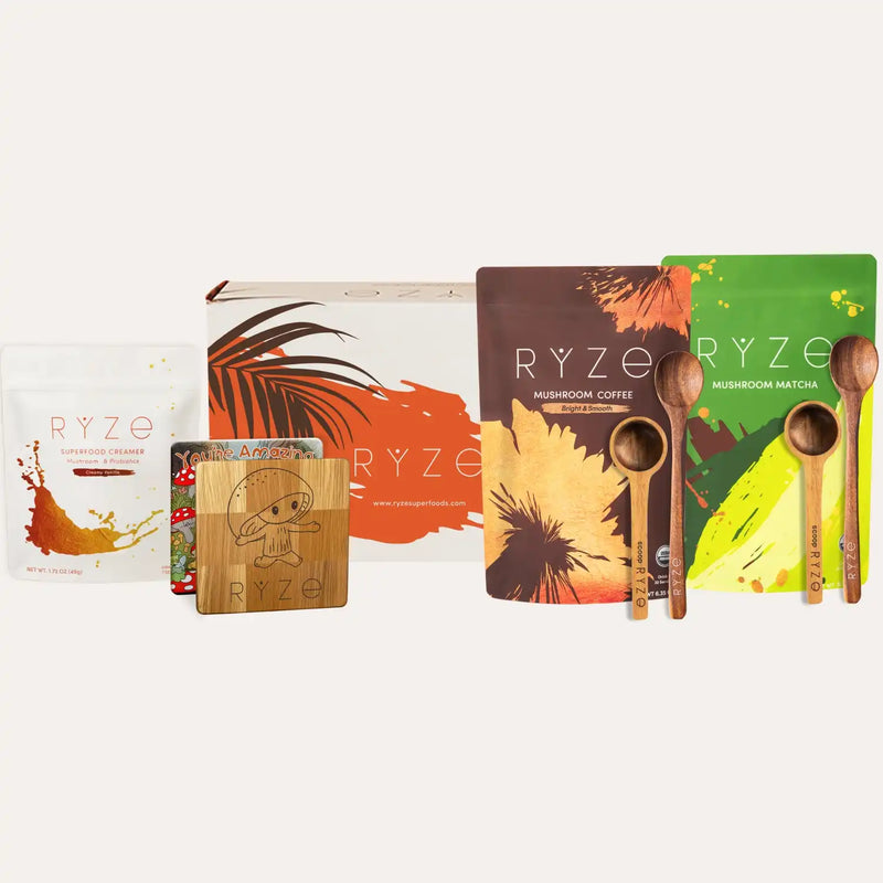 Collection of RYZé mushroom product packaging and wooden spoons on a white background