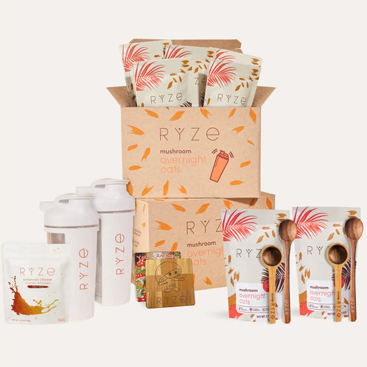 Ryze mushroom overnight oats packaging with cartons, shakers, and wooden spoons on a white background