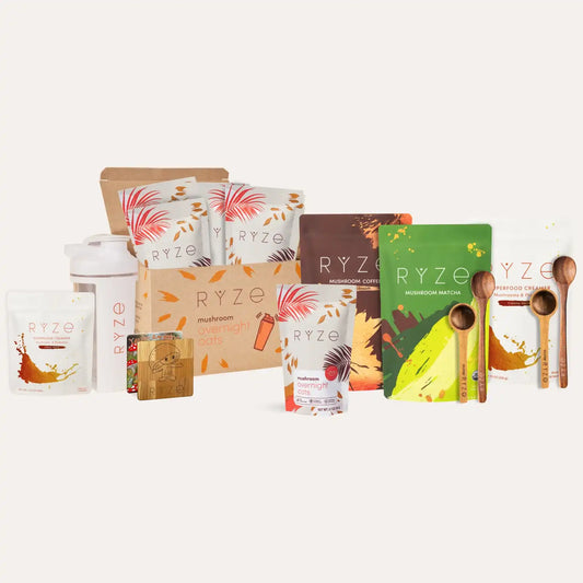 Collection of RYZE products including packaging and wooden spoons on a white background