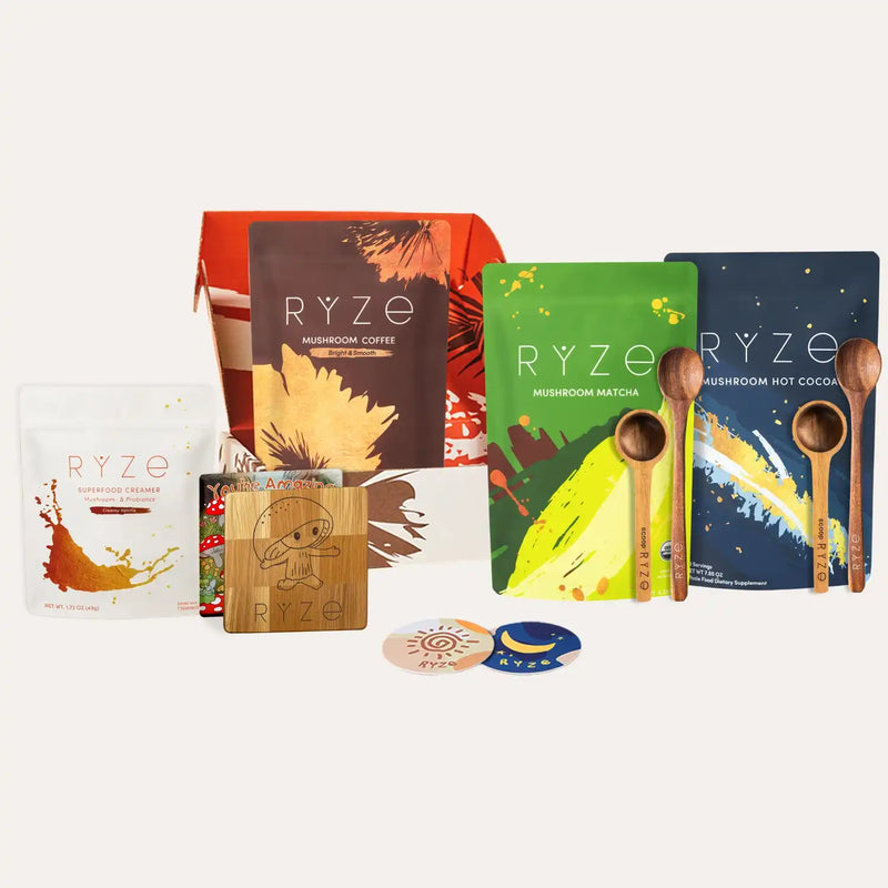 Collection of RYZé mushroom product packages and wooden spoons on a white background