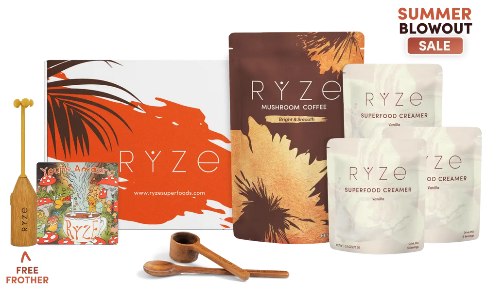 A product bundle from RYZE featuring a large orange and white gift box, a brown pouch of mushroom coffee, three white pouches of superfood creamer, two wooden measuring spoons, and a wooden frother, arranged on a white background with a 'Summer Blowout Sale' promotional badge.