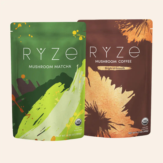 Two stand-up pouches of RYZE Mushroom Coffee shown on a light beige background. The left pouch is green and labeled Mushroom Matcha, and the right pouch is brown and labeled Bright & Smooth Mushroom Coffee.