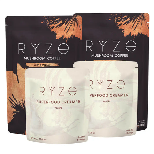 Four RYZE-branded stand-up pouches arranged together on a white background: two dark brown mushroom coffee pouches in back and two pale cream creamer pouches in front labeled Superfood Creamer, Vanilla.
