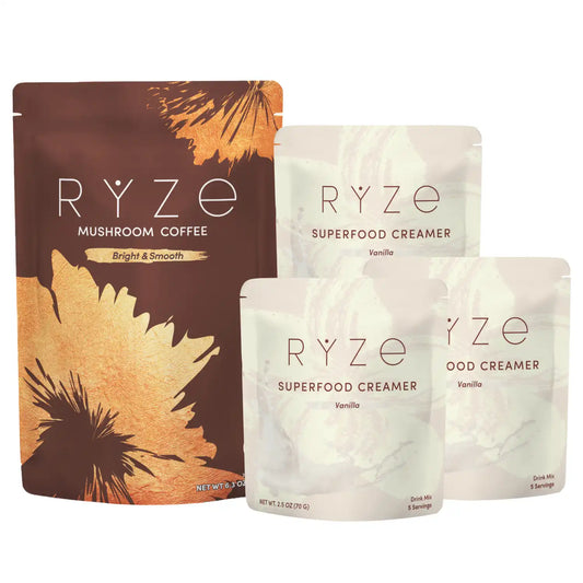 Four RYZE-branded stand-up pouches of coffee and creamer products on a plain white background: a larger brown pouch labeled Mushroom Coffee, and three smaller off-white pouches labeled Superfood Creamer with Vanilla visible on the creamer packs.