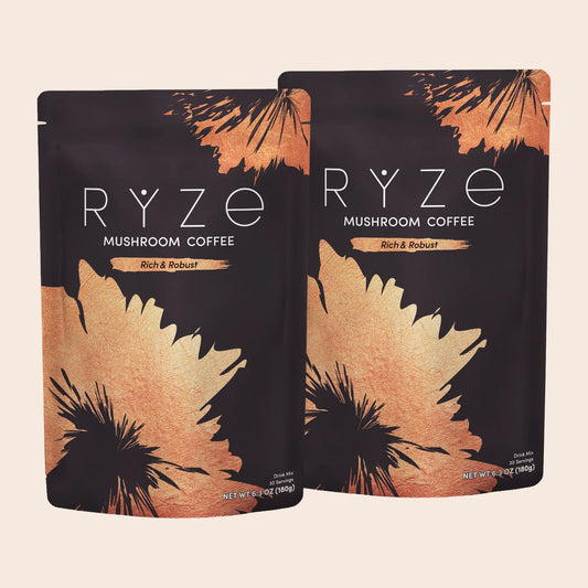 Two stand-up pouches of RYZE Mushroom Coffee, Rich & Robust flavor, displayed against a solid light beige background.