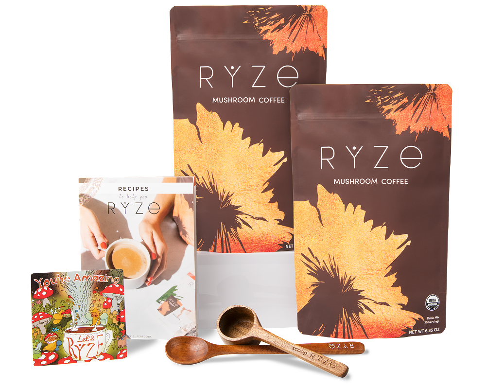 Rye mushroom coffee packs with wooden scoops and recipe booklet displayed.